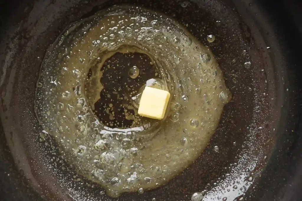 Butter melting in a hot skillet before cooking crispy homemade cheese quesadillas
