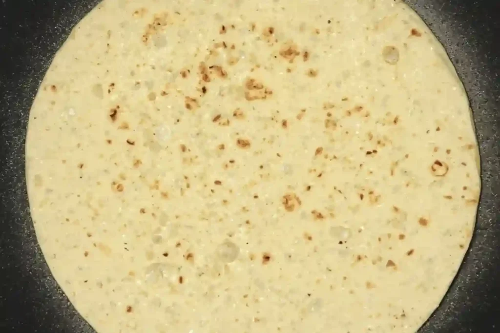 Flour tortilla lightly toasted in a skillet before adding cheese for crispy homemade quesadillas