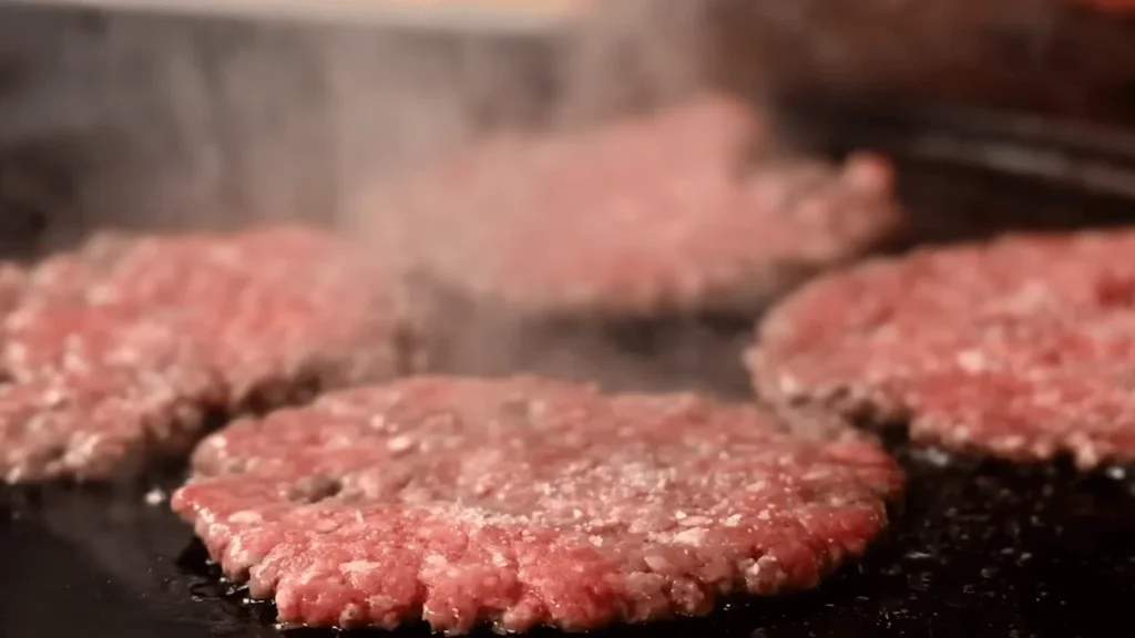 Chicken patties frying until golden brown for a homemade McChicken Burger Recipe