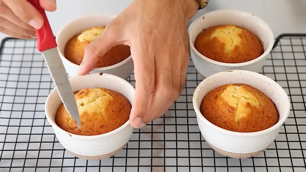 Freshly baked vanilla cakes cooling on a wire rack before frosting and decorating
