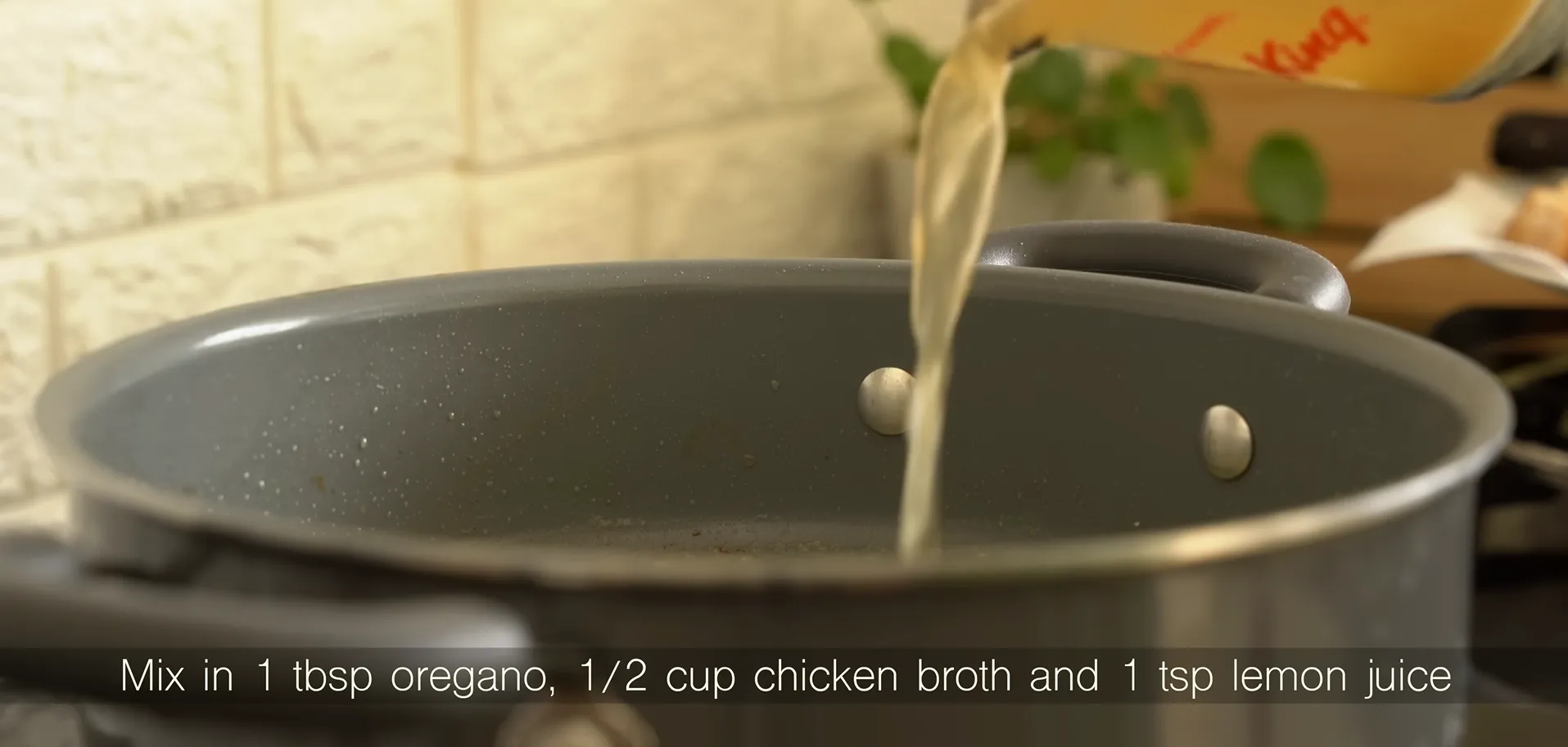 Pouring chicken broth and fresh lemon juice into a skillet to make a garlic butter sauce base