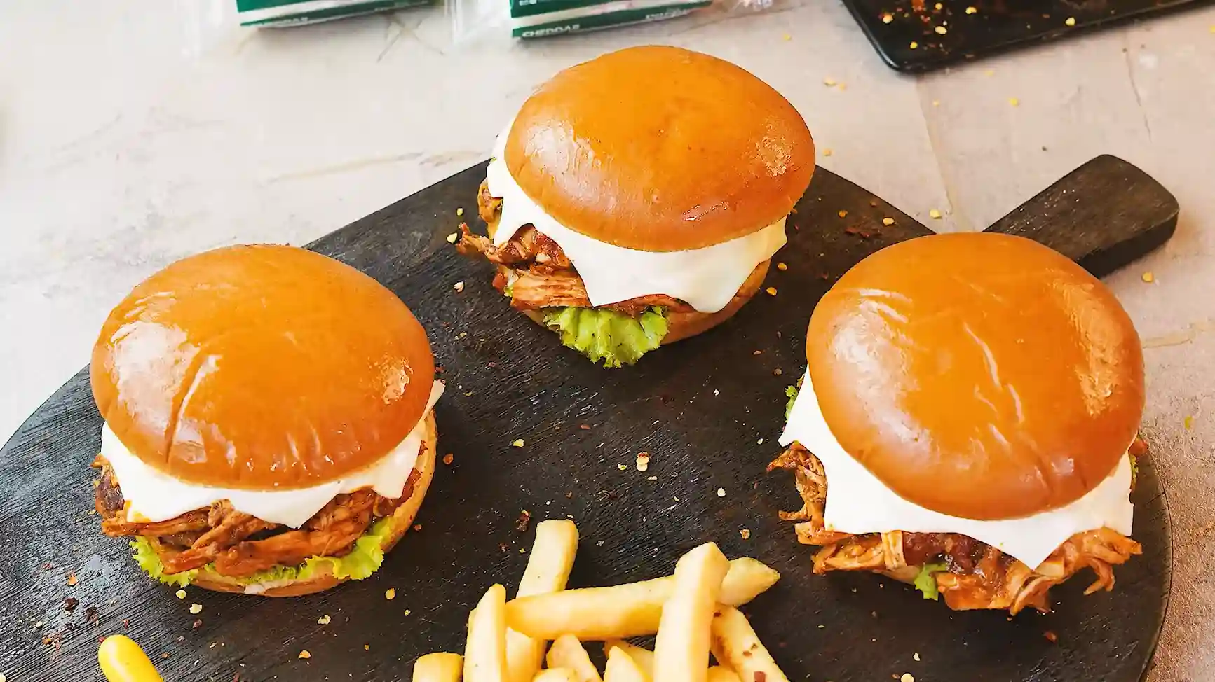 BBQ cheeseburgers served with crispy French fries
