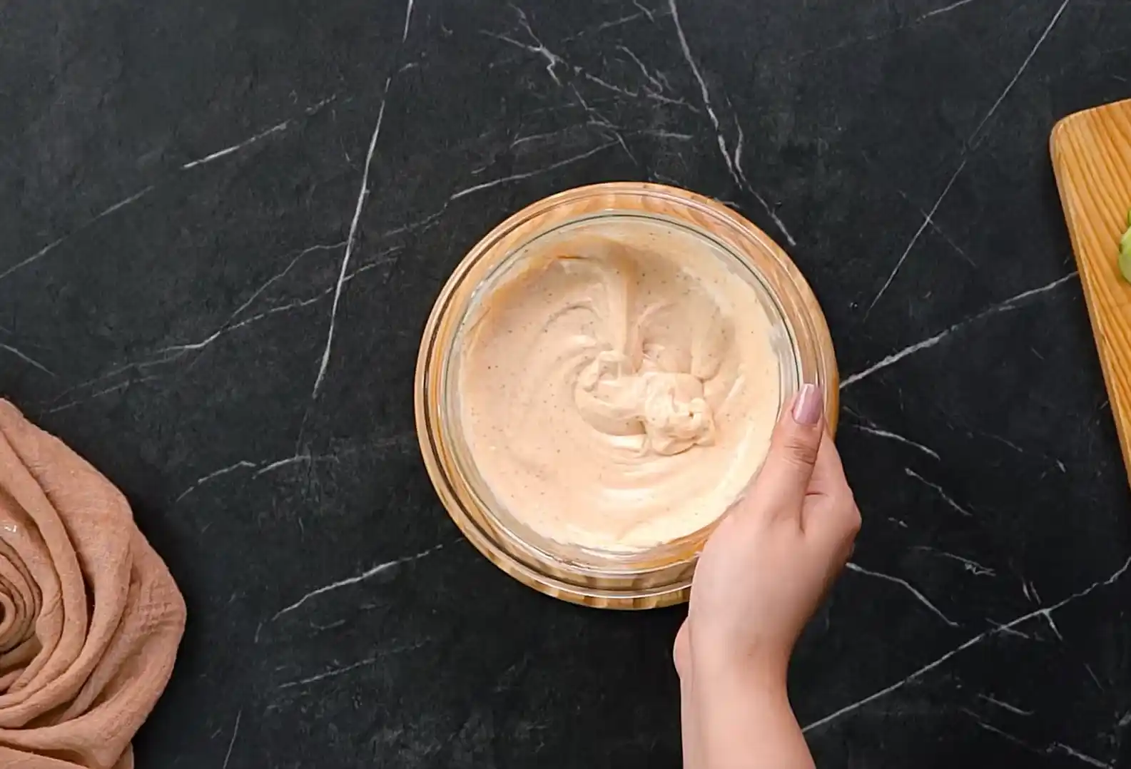 Finished smooth spicy mayo sauce in a small glass bowl