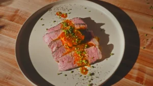Gordon Ramsay Inspired Steak Recipe sliced and served on a plate with butter basting