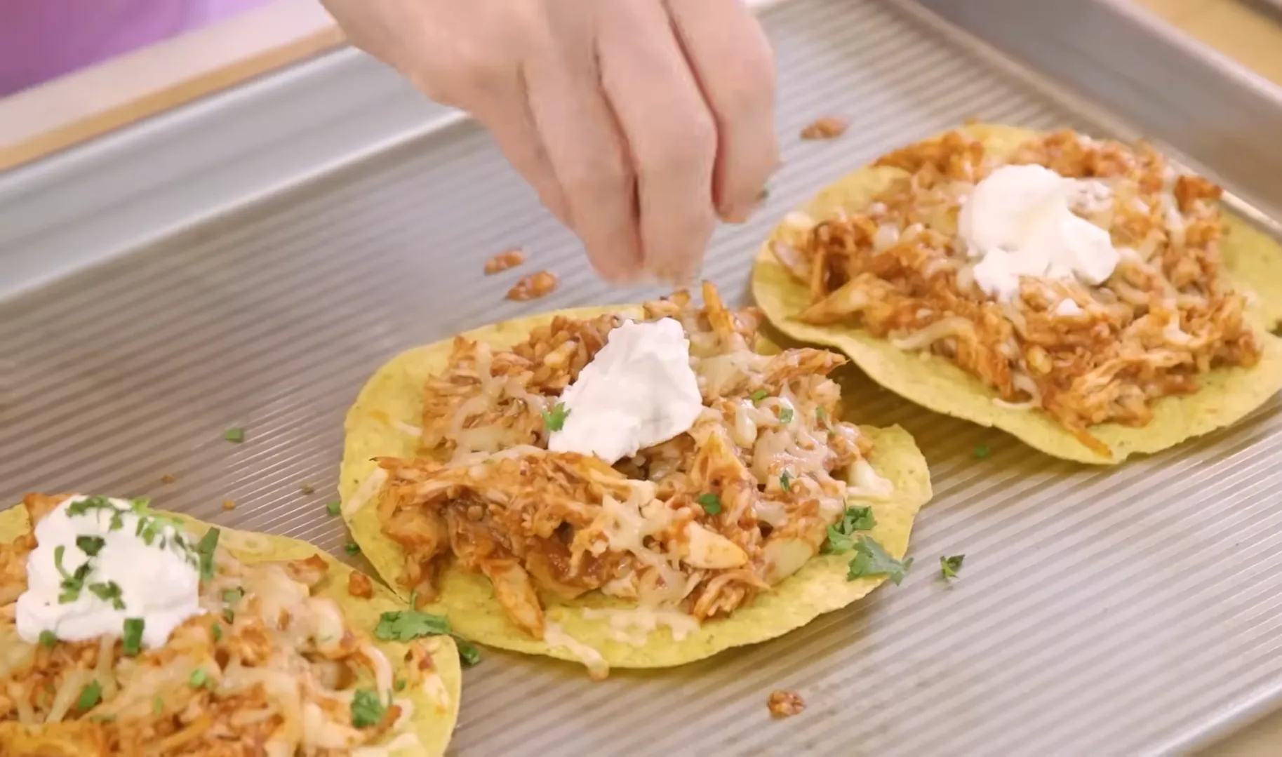 Finish with a dollop of sour cream and fresh cilantro for the perfect weeknight tostadas Easy chicken tostadas topped with melted cheese, sour cream, and fresh cilantro