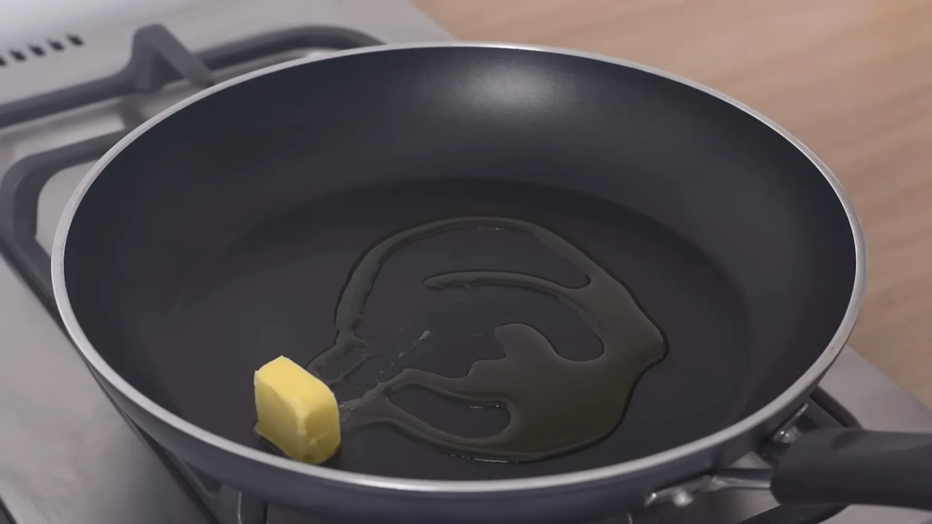 butter and olive oil melting in nonstick pan butter and olive oil melting in nonstick pan