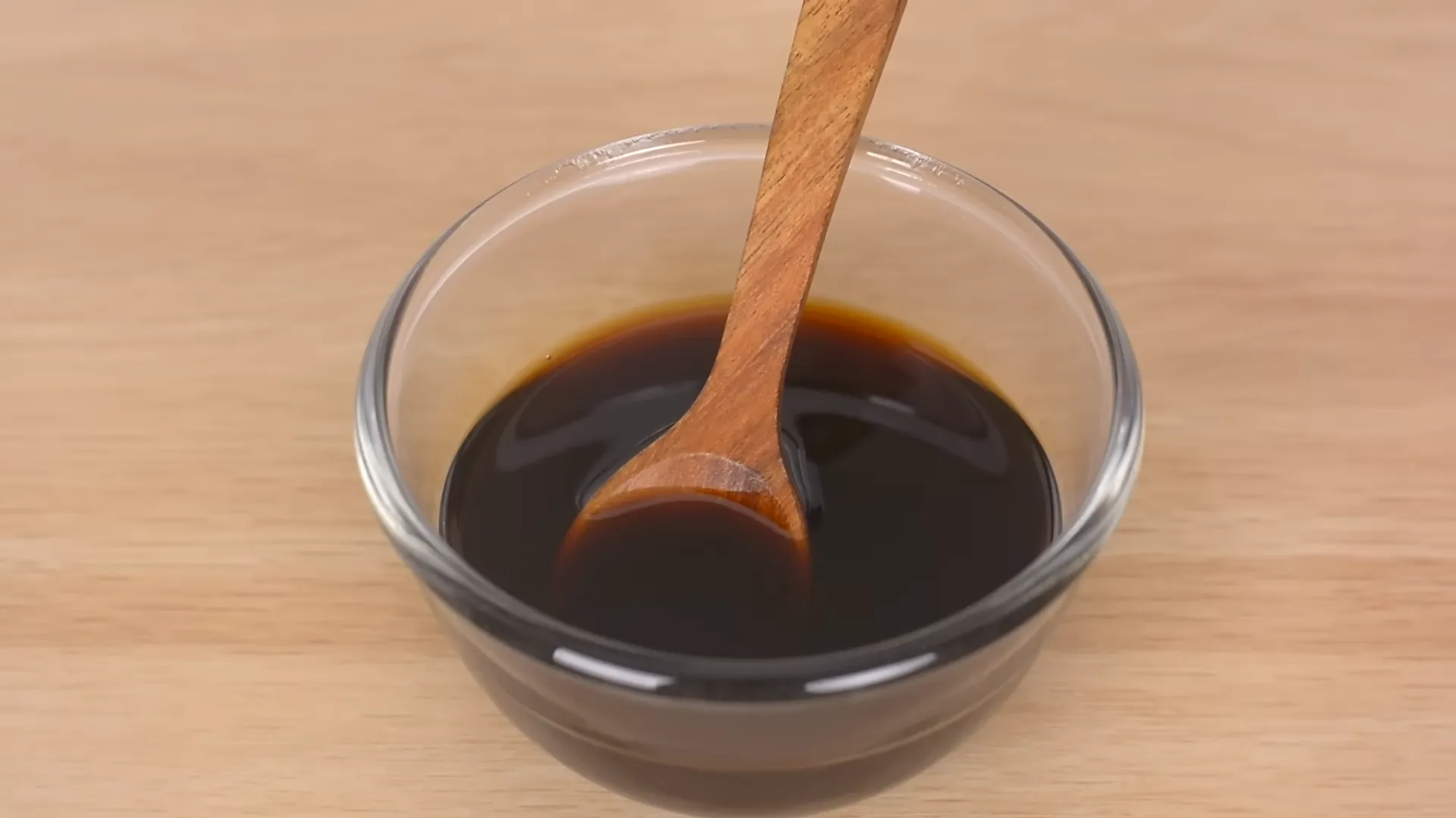 soy sauce and honey glaze mixed in glass bowl with wooden spoon soy sauce and honey glaze mixed in glass bowl with wooden spoon