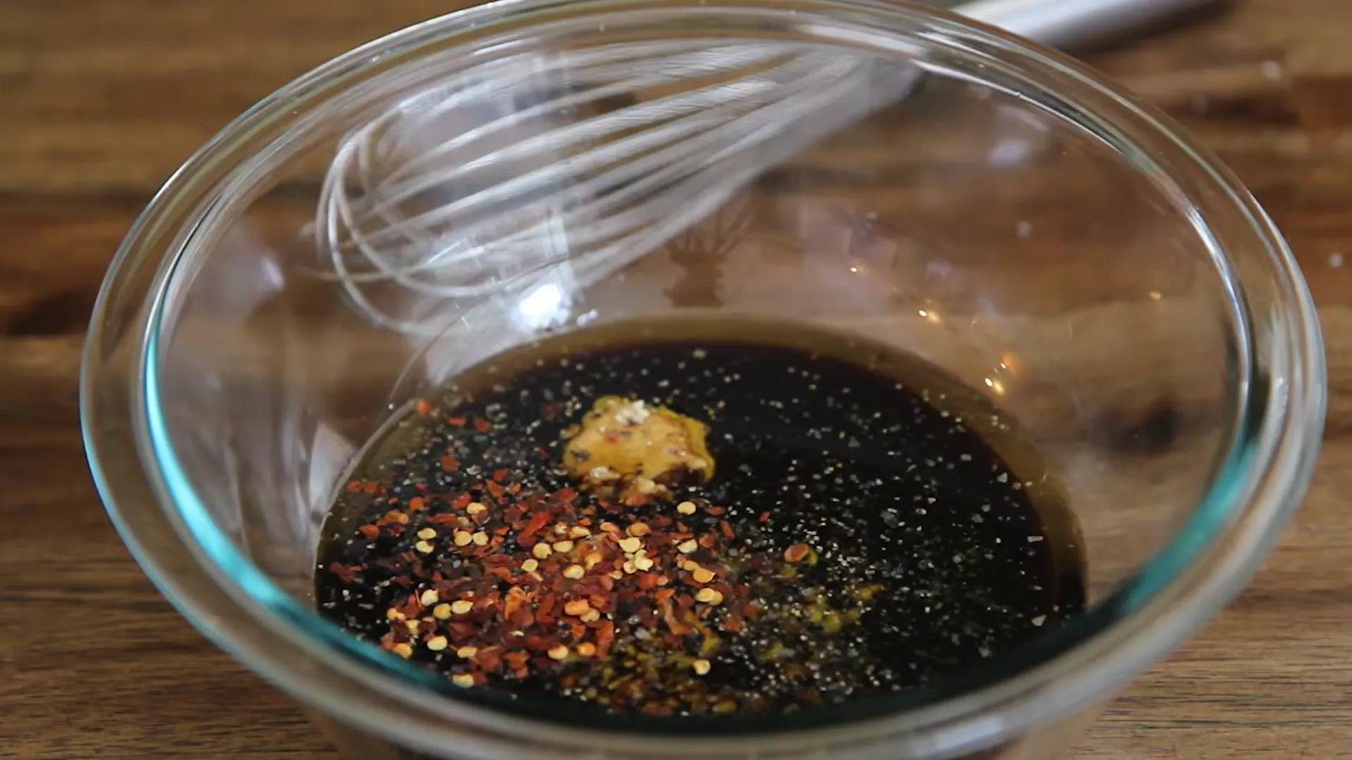 Red pepper flakes, black pepper and Dijon mustard added to homemade steak marinade before whisking