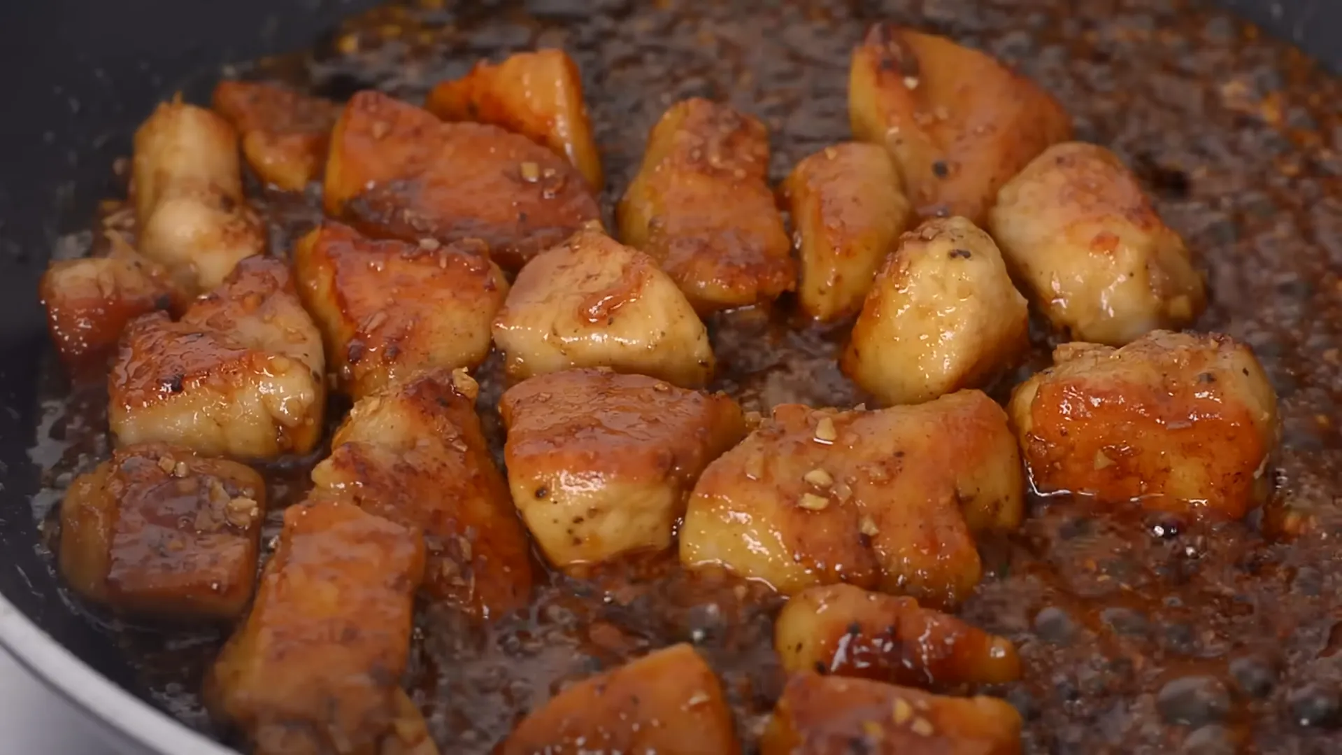 glazed chicken bites coated in sticky garlic soy sauce in pan glazed chicken bites coated in sticky garlic soy sauce in pan