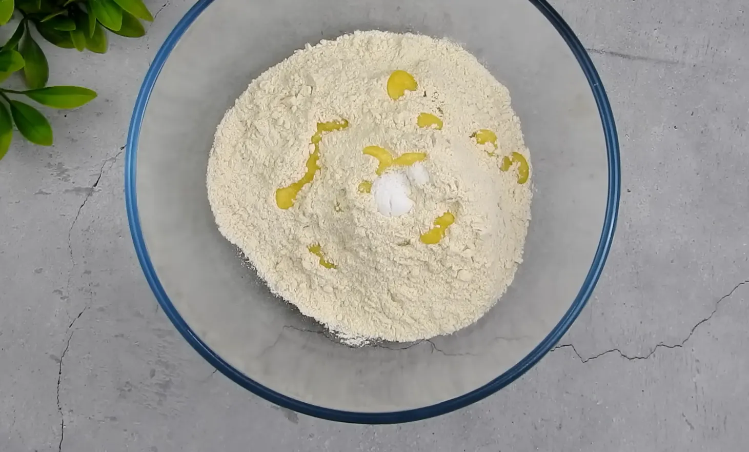 Whole wheat flour mixed with oil and salt in a bowl for paratha dough