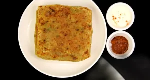 Hot crispy square onion paratha served with yogurt and chutney