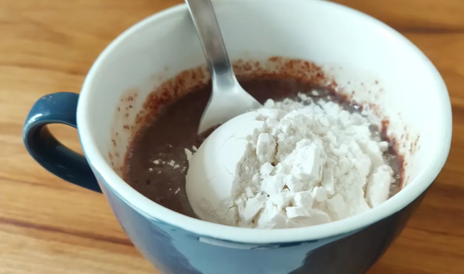 Adding flour to chocolate mug cake batter