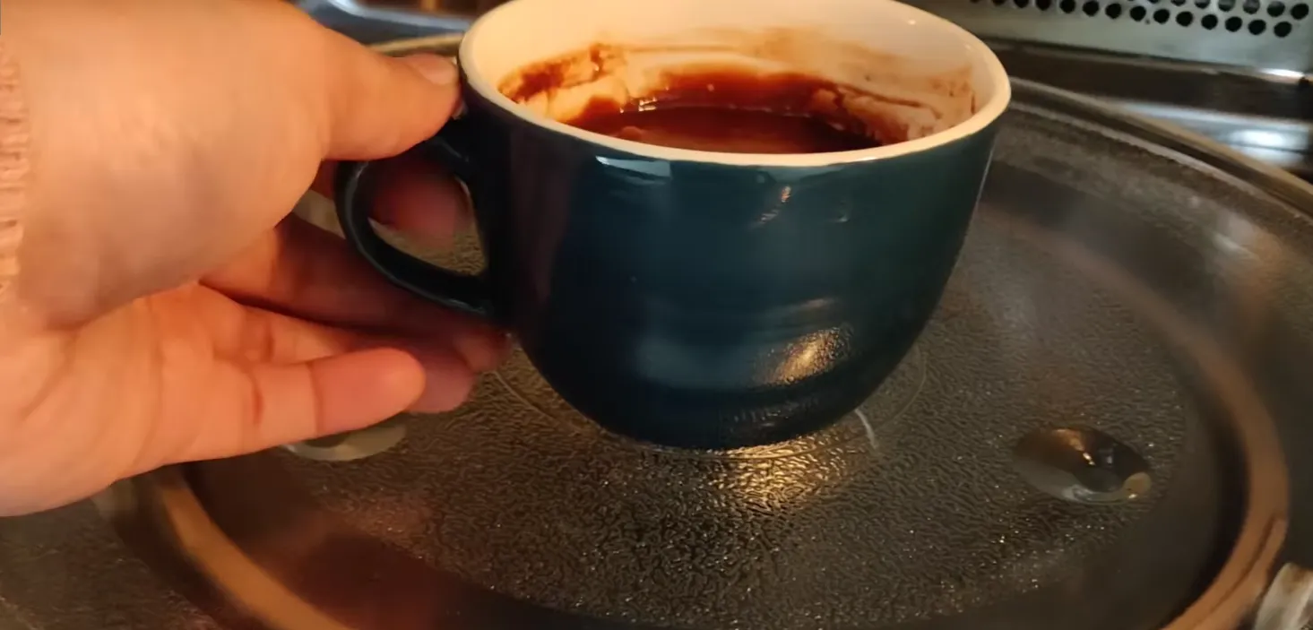 Placing chocolate mug cake in microwave to cook