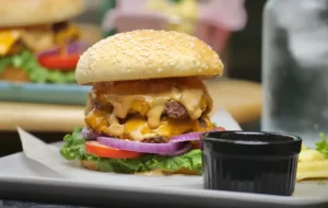 Double smash burger with melted cheese and sauce dripping down the sides