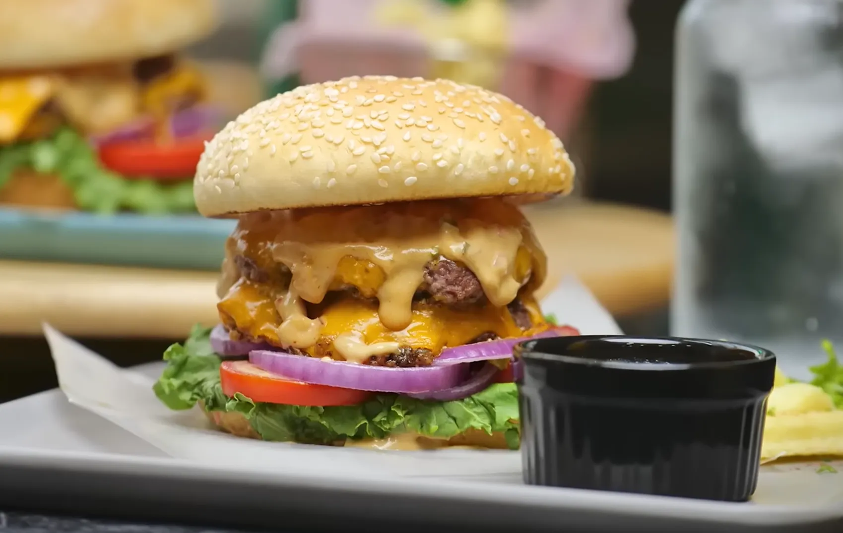 Double smash burger with melted cheese and sauce dripping down the sides